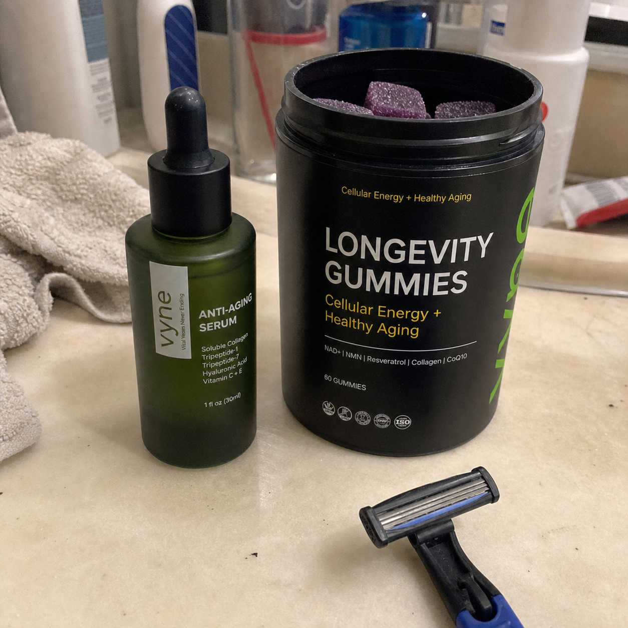 Customer photo of VYNE serum and gummies on a bathroom counter